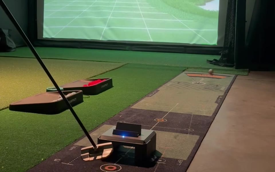 A LagKing gate in a golf simulator bay, the putt on the projector screen