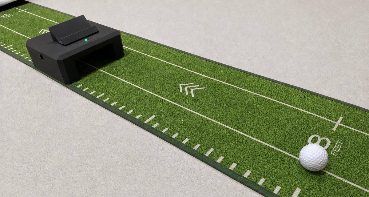 A LagKing gate sitting square across a putting mat with a ball on the line in front of it and the status light glowing green.